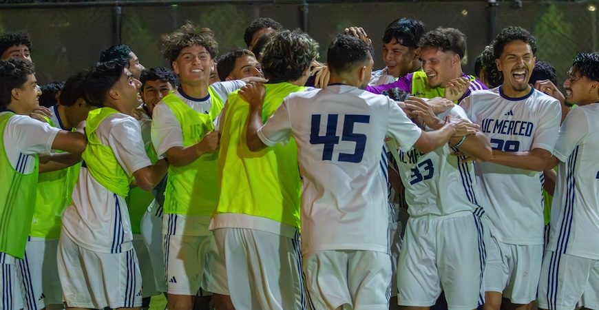 Members of the UC Merced soccer team celebrate a win. 
