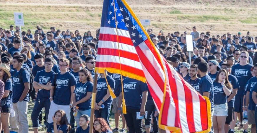 U.S. flag flies in front of UC Merced students